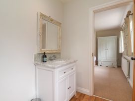 A bathroom with a vanity and mirror at 21 Eskdaleside Sleights