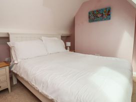 A bedroom with a bed and nightstand at 21 Eskdaleside Sleights