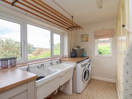 A laundry room with a wash basin and washing machine at 21 Eskdaleside Sleights