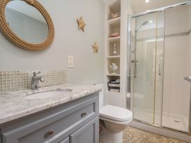 A bathroom with a sink, shower, and toilet at 21 Eskdaleside, Sleights