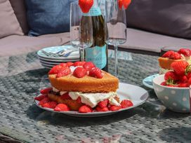 A cake with strawberries and prosecco on a table at 21 Eskdaleside Sleights