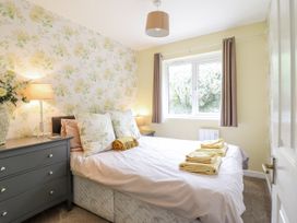 A bedroom with a bed and nightstand at 8 Glan Ysgethin in Barmouth