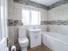 A bathroom with a toilet, sink, and bathtub at 8 Glan Ysgethin Barmouth