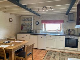 A kitchen with a table and chairs at The Granary in Mansergh near Kirkby Lonsdale