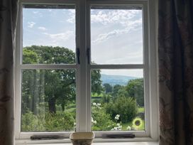 A window view showing trees and a field at The Granary in Mansergh near Kirkby Lonsdale