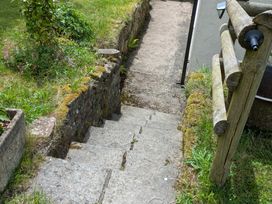 Steps leading down to a pathway with grassy areas at Pool House The Narth near Trellech