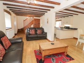 A living room with sofas and a coffee table at Stabal-y-Gwedd in Dolwen near Abergele