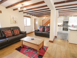 A living room with a coffee table and sofas at Stabal-y-Gwedd in Dolwen near Abergele