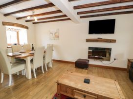 A dining room with a table and chairs at Stabal-y-Gwedd, Dolwen near Abergele