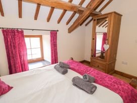 A bedroom with a bed and towels on it at Stabal-y-Gwedd in Dolwen near Abergele