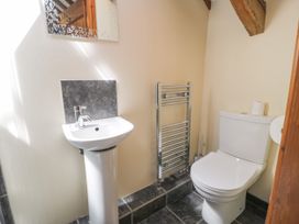A bathroom with a sink, toilet and towel radiator at Stabal-y-Gwedd in Dolwen near Abergele