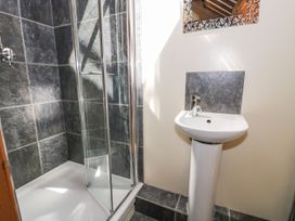 A bathroom with a shower and wash basin at Stabal-y-Gwedd in Dolwen near Abergele