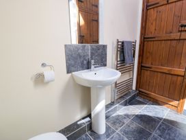 A bathroom with a sink and towel rack at Stabal-y-Gwedd in Dolwen near Abergele