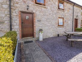 A stone exterior entrance with a door and windows at Beudy Bach in Dolwen near Abergele
