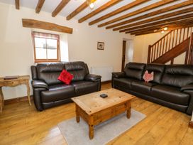 A living room with sofas and a coffee table at Beudy Bach Dolwen near Abergele