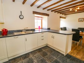 A kitchen with a sink and cabinet at Beudy Bach in Dolwen near Abergele