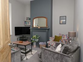 A living room with a television and sofa at Number Thirty-Nine in Ulverston