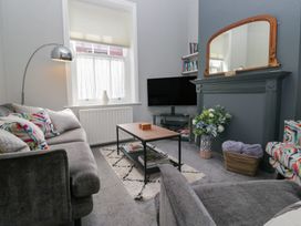 A living room with a sofa and television at Number Thirty-Nine in Ulverston