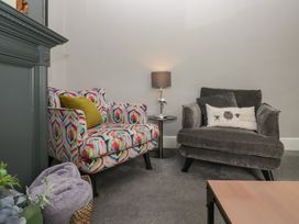 A living room with colorful armchairs and a side table at Number Thirty-Nine in Ulverston