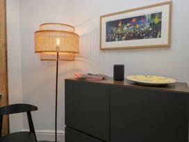 A room with a lamp, cabinet, picture, and a plate at Number Thirty-Nine in Ulverston