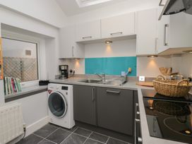 A kitchen with a washing machine and coffee maker at Number Thirty-Nine in Ulverston