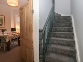 A hallway with a staircase and door leading to a dining area at Number Thirty-Nine in Ulverston