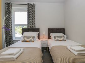 A bedroom with twin beds and a window at Number Thirty-Nine Ulverston