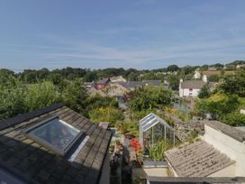 A view of a garden with a greenhouse and rooftops at Number Thirty-Nine in Ulverston