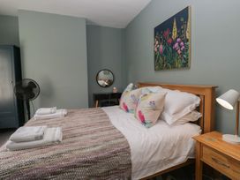 A bedroom with a bed and wooden furniture at Number Thirty-Nine in Ulverston