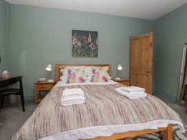 A bedroom with a bed and side table at Number Thirty-Nine in Ulverston