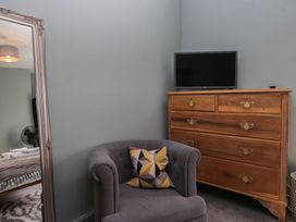 A bedroom with a chair and chest of drawers at Number Thirty-Nine in Ulverston