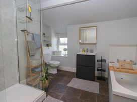 A bathroom with a shower, toilet, sink, and bath at Number Thirty-Nine in Ulverston