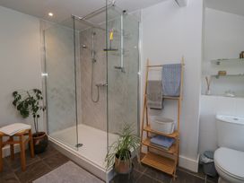 A bathroom with a shower and plant at Number Thirty-Nine in Ulverston
