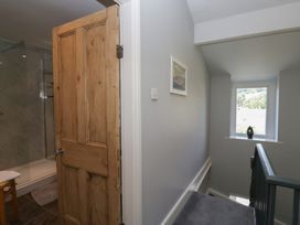 A hallway with a door leading to a shower at Number Thirty-Nine in Ulverston