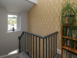A staircase with a window and bookshelf at Number Thirty-Nine in Ulverston