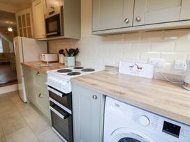 A kitchen with appliances and countertop at Cobbler's Cottage Mundesley