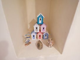 A display of decorative houses and shells in a niche at Cobbler's Cottage Mundesley