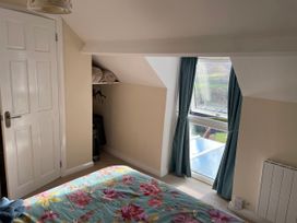 A bedroom with a window and blankets on a shelf at Willow Nook in Glaisdale near Lealholm