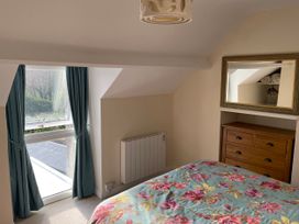 A bedroom with a bed and dresser at Willow Nook in Glaisdale near Lealholm