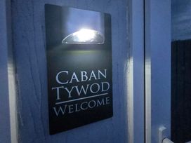 A welcome sign with light at Caban Tywod in Abersoch