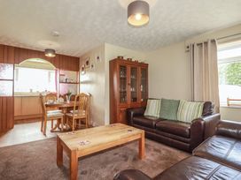 A living room with a dining area and furniture at Underlanes in Boscastle