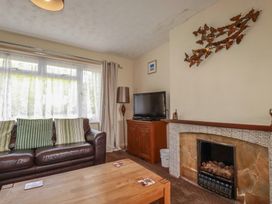 A living room with a sofa, television and coffee table at Underlanes in Boscastle