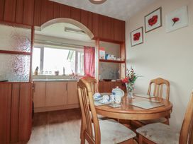 A kitchen with a table and chairs at Underlanes in Boscastle