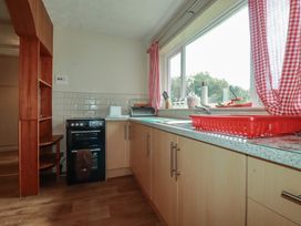 A kitchen with a stove and sink at Underlanes in Boscastle