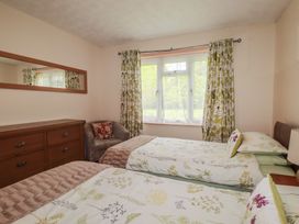 A bedroom with two beds and a dresser at Underlanes in Boscastle
