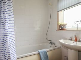 A bathroom with a bathtub and sink at Underlanes in Boscastle