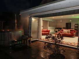 An outdoor area with a hot tub and a seating arrangement at Milton Manor in Milton On Stour