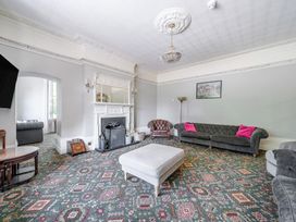 A living room with sofas, a fireplace and a coffee table at Milton Manor in Milton On Stour