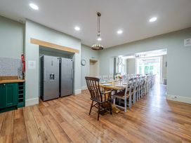 A kitchen with refrigerators and a dining area at Milton Manor in Milton On Stour