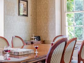 A dining room with a table and chairs at Milton Manor in Milton On Stour
